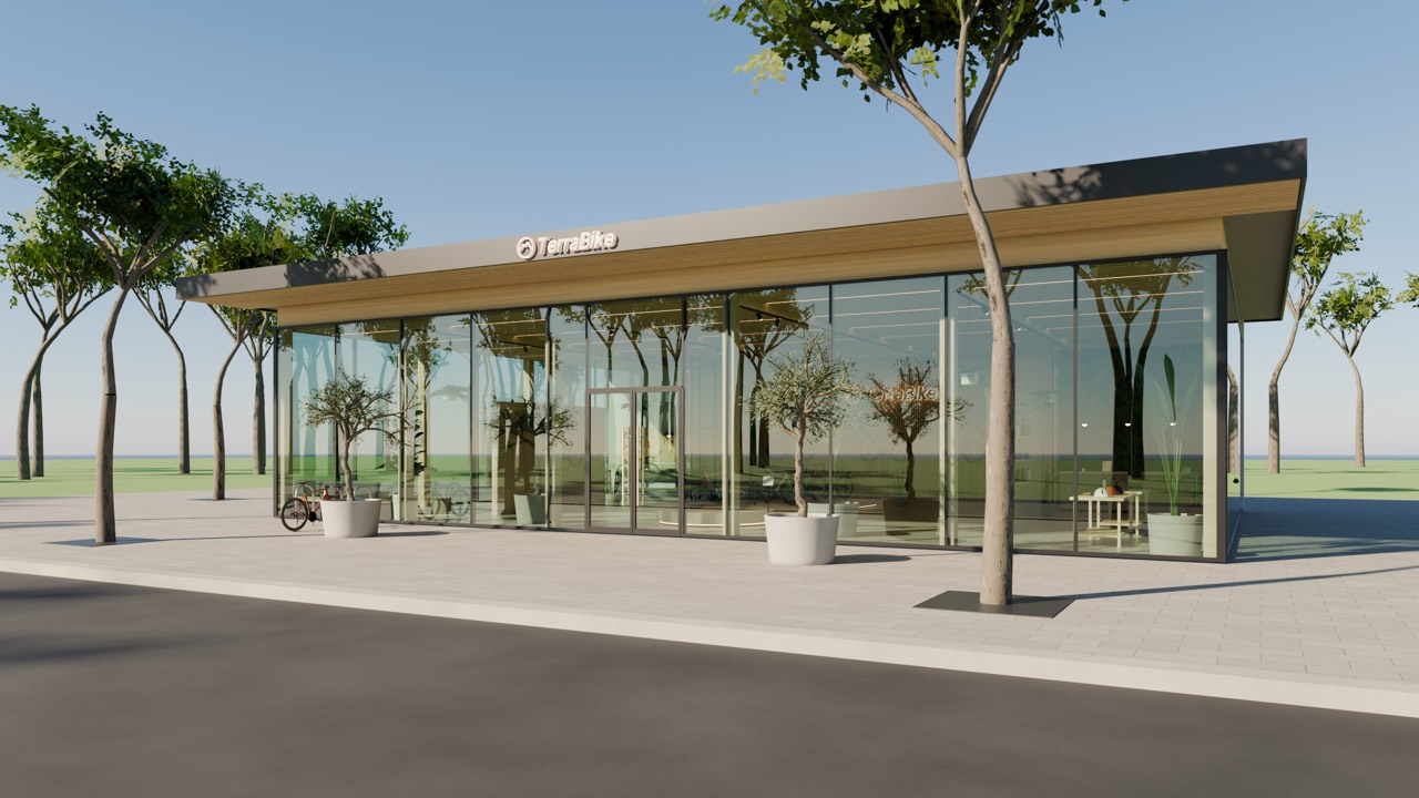 Exterior of the glass-fronted showroom pavilion under a timber roof, lined with trees.